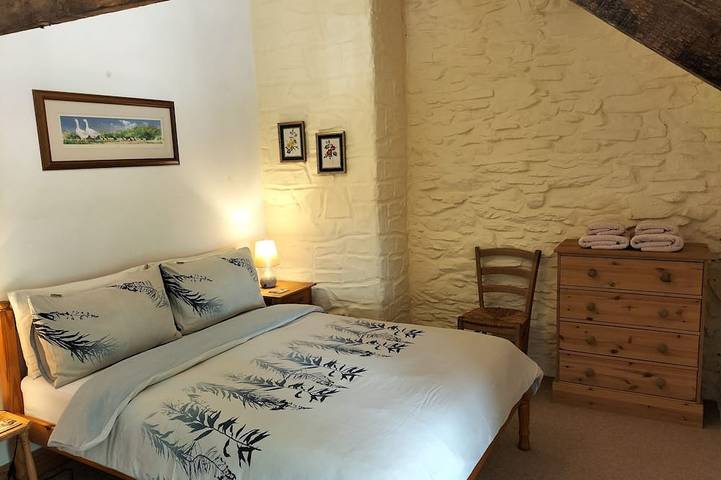 A cosy former horse stable with stone walls and old beams throughout in Ceredigion