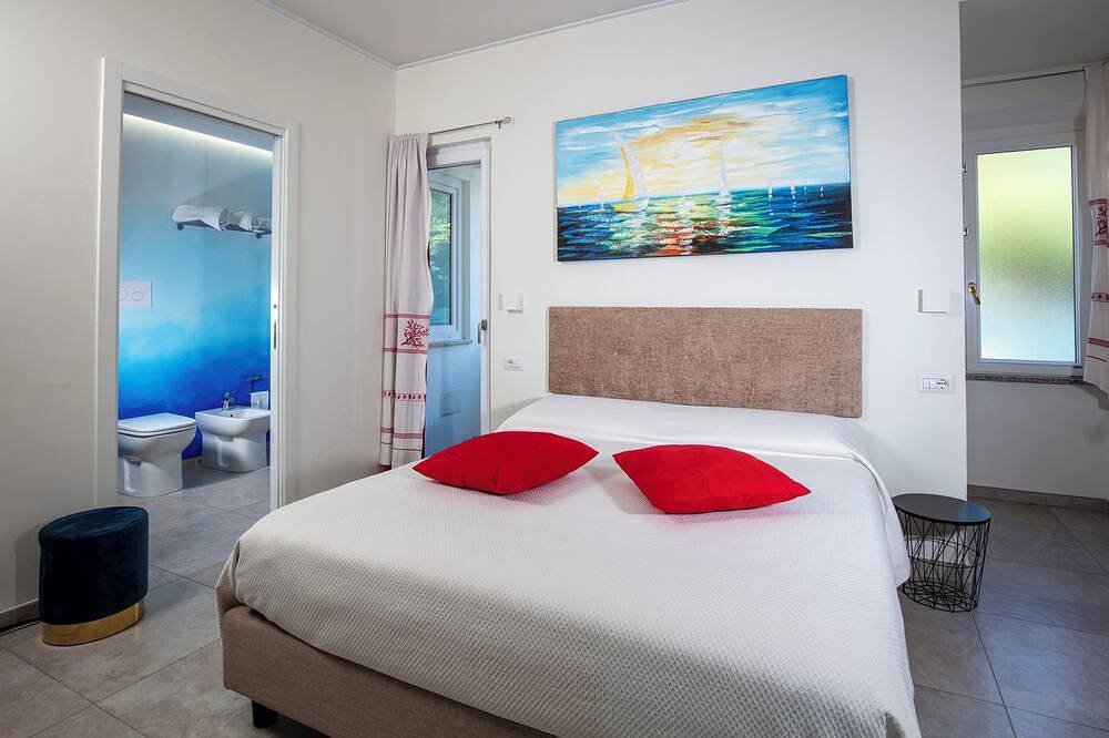Family room with mountain view terrace and window overlooking the harbor. in Cala Gonone, Dorgali