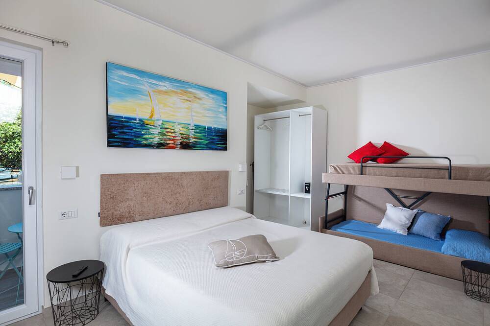 Family room with mountain view terrace and window overlooking the harbor. in Cala Gonone, Dorgali