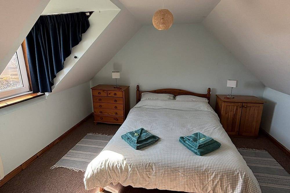 Traditionelles Hochlandhaus mit atemberaubendem Panoramablick auf die Berge und das Meer in Highlands