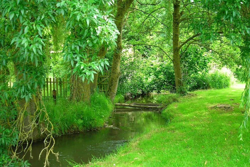 Chalet tranquille au bord de la rivière dans un parc de moulin à eau. in Lhomme, Sarthe