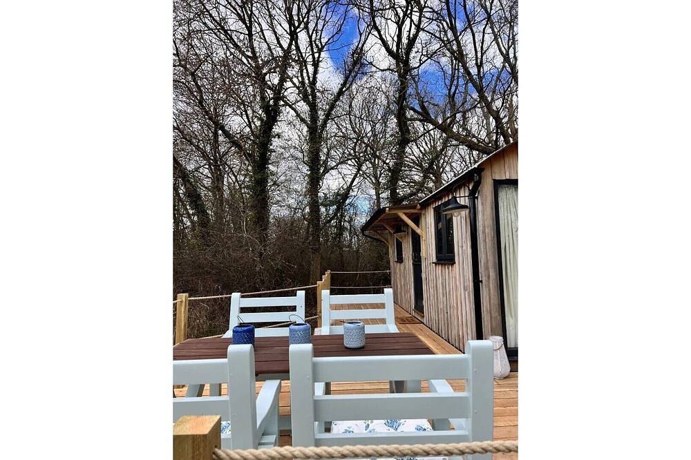 Boutique Shepherds Hut set in a wildflower meadow on a farm with Highland Cows in West Chiltington, South Downs