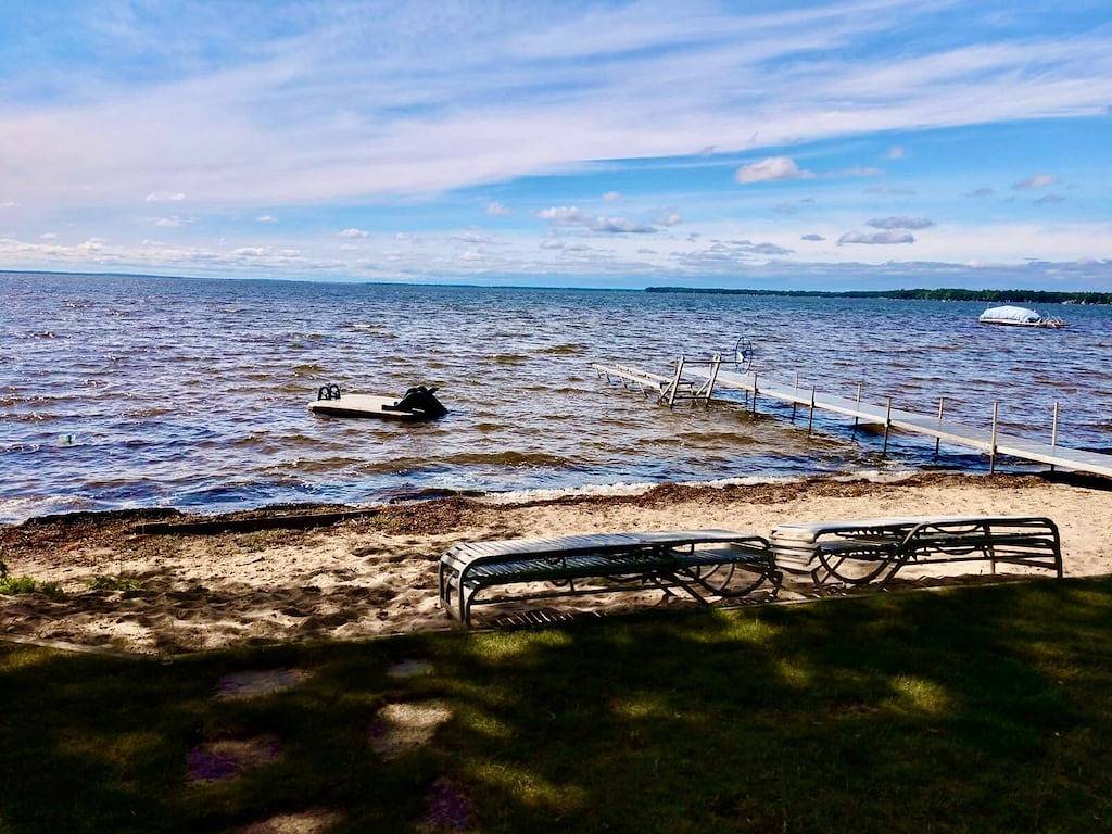 New Listing! Lake front cottage with 100' of private sandy beach in Prudenville, Roscommon County