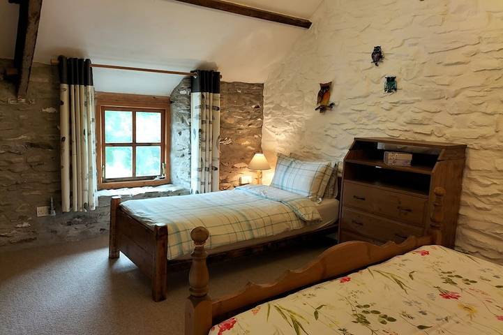 A cosy former horse stable with stone walls and old beams throughout in Ceredigion