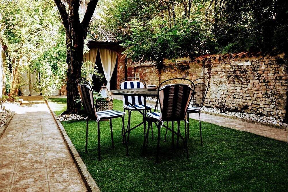 A garden in the shadow of the Torrazzo in Cremona, Cremona Province