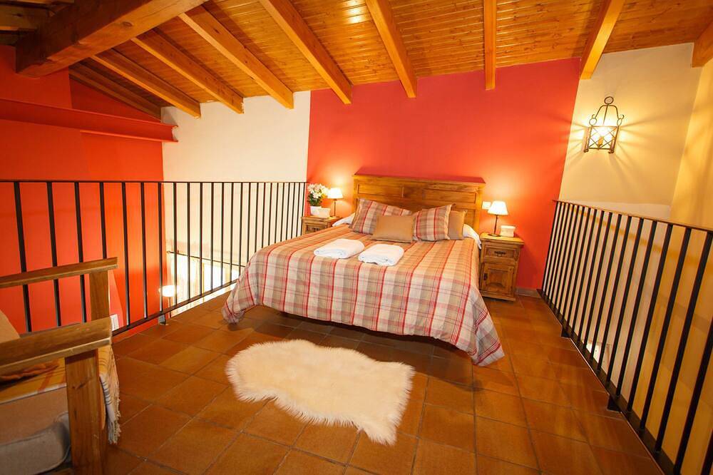 La Fragua is a beautiful little house with a gable roof built in stone and wood in Piñuécar, Madrid Province