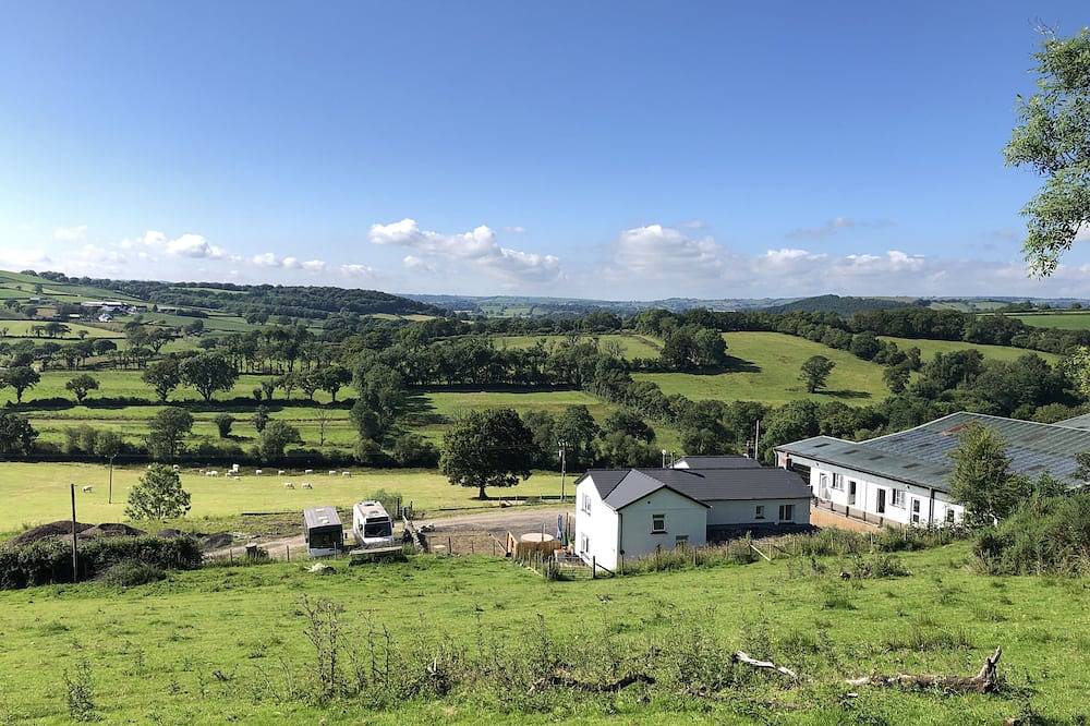 Farm setting with large living areas and wood fired hot tub in Carmarthen, Carmarthenshire