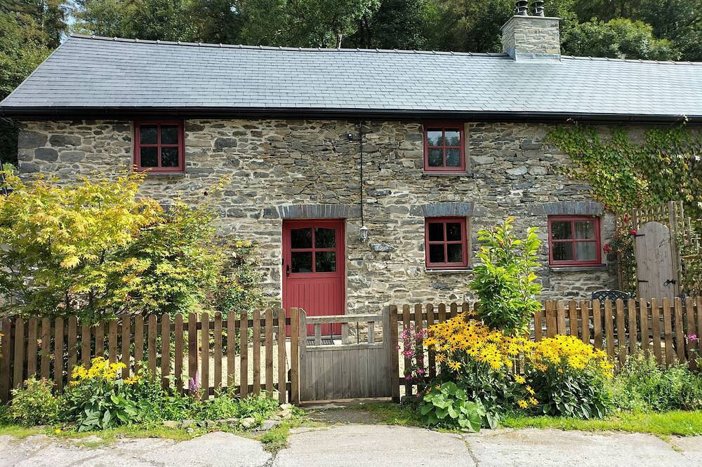 A cosy former horse stable with stone walls and old beams throughout in Ceredigion