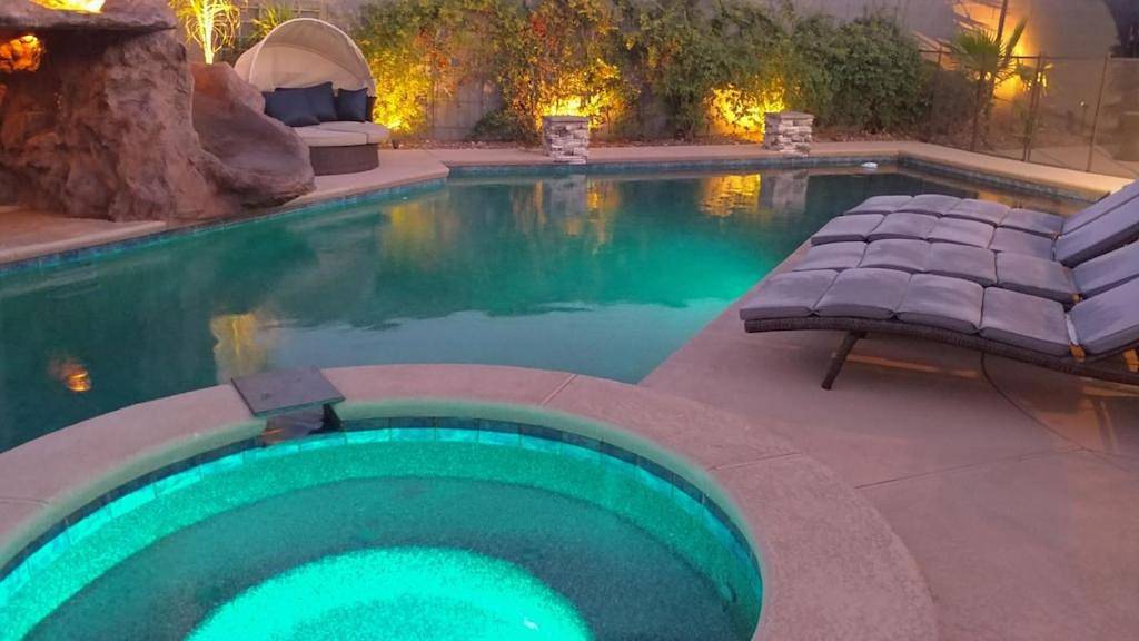 Luxury Villa, with bonus pool house, Private Pool, Hot tub, rock water fall and slide, putting green, basketball, shuffle board, play gym, privately gated on circular driveway. in Las Vegas, Red Rock Canyon