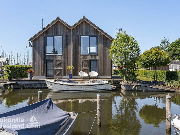 Ferienhaus für 4 Personen, mit Balkon/Terrasse und Balkon sowie Terrasse und Garten