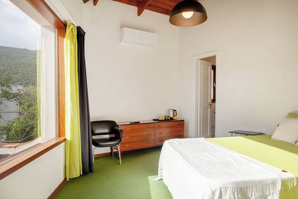 Villa surrounded by green hills overlooking the sea in Poggio dei Pini, Capoterra