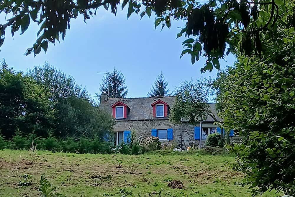 House with blue shutters. in Mellionnec, Guingamp Region