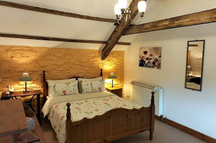 A cosy former horse stable with stone walls and old beams throughout in Ceredigion