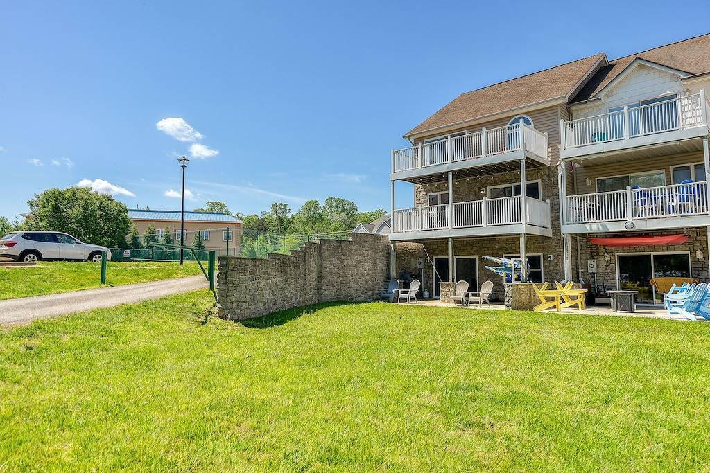 Three-story lakefront home w/ covered boat slip, and tennis/pickleball access in Lake Anna