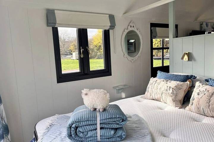 Boutique Shepherds Hut set in a wildflower meadow on a farm with Highland Cows in West Chiltington, South Downs