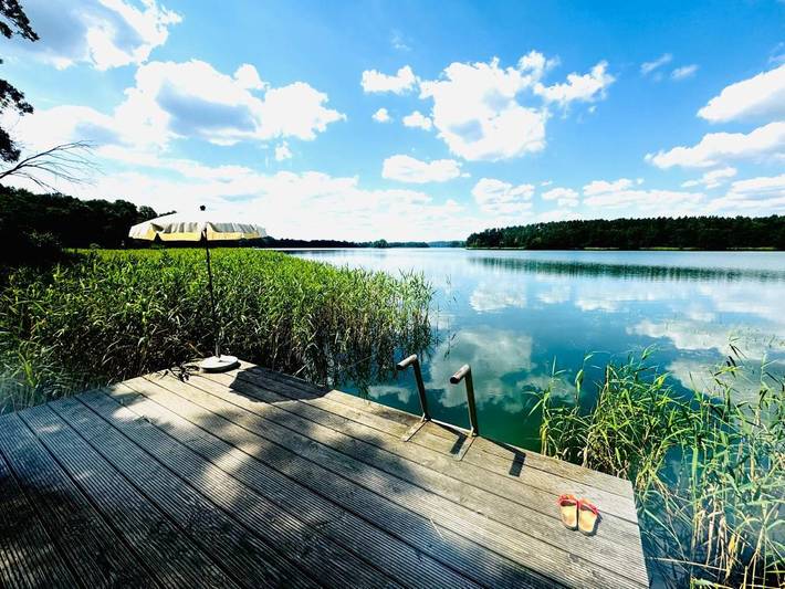 Ferienwohnung für 4 Personen, mit Terrasse und Garten sowie Sauna und Seeblick