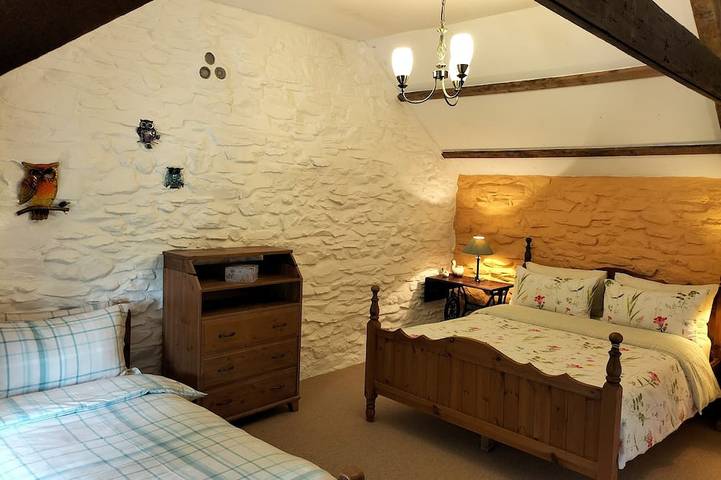 A cosy former horse stable with stone walls and old beams throughout in Ceredigion