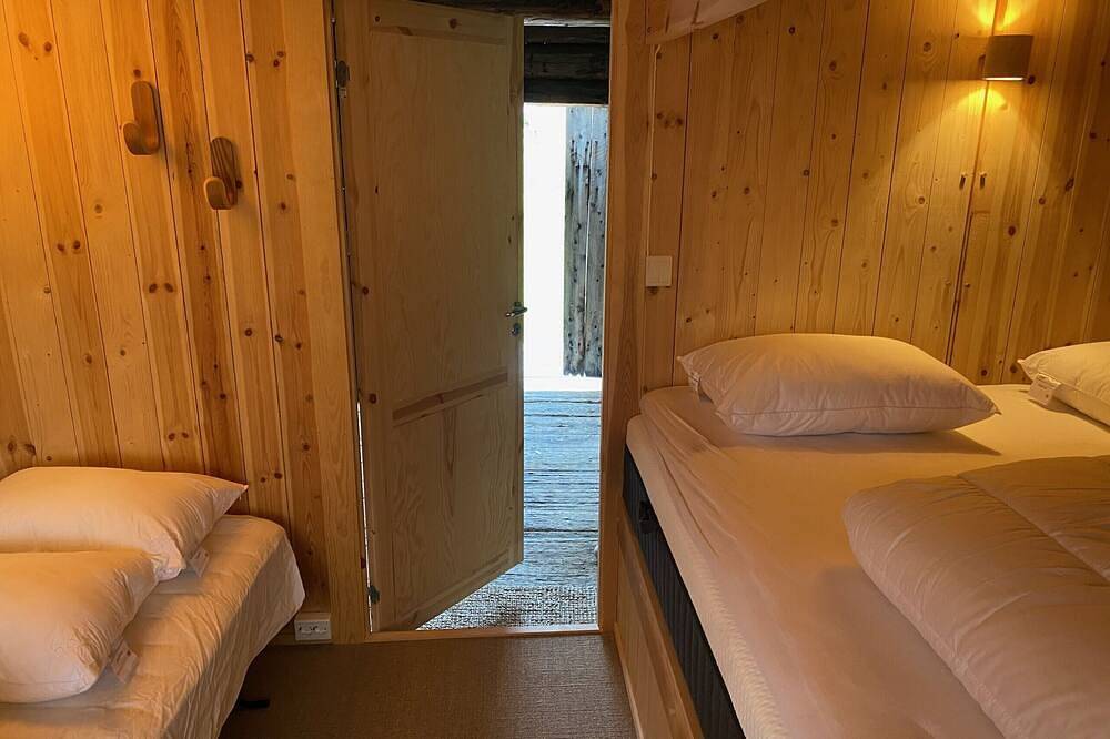 Architect designed sleeping box in barn in Ål