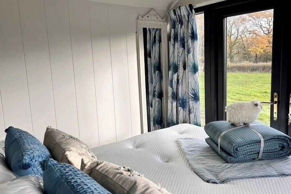 Boutique Shepherds Hut set in a wildflower meadow on a farm with Highland Cows in West Chiltington, South Downs