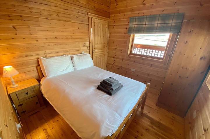 A traditional Scandinavian style lodge, with stylish wooden interior decorated with a Scottish theme in Lothian