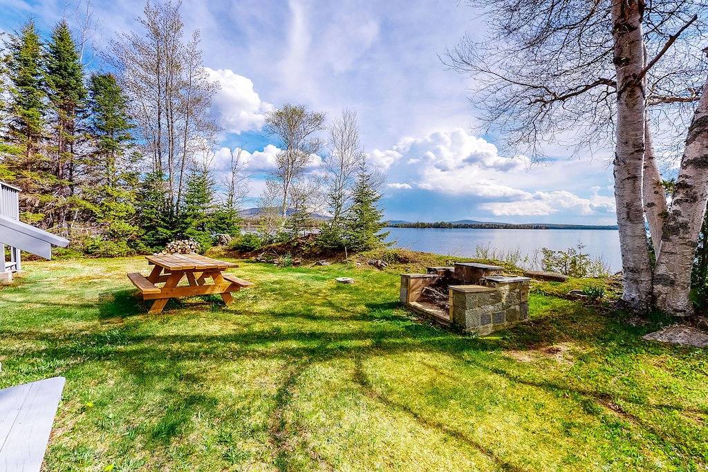 Lakefront home with private dock, mooring, pebble beach, grill, & firepit in Moosehead Lake