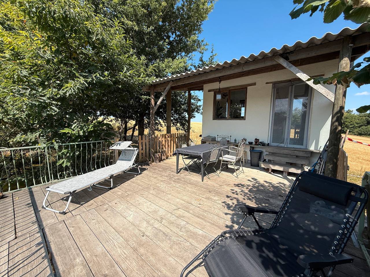 Entire holiday apartment, Tiny Home 'Bord De L'étang - Iri' with Lake View, Shared Pool and Private Terrace in Champsac, Périgord-Limousin Regional Nature Park