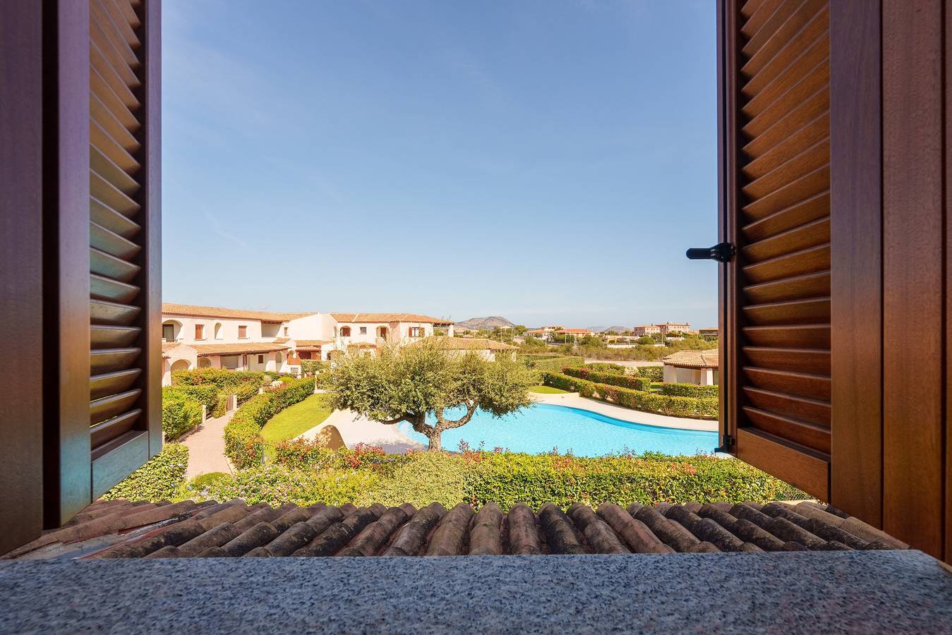 Appartamento intero, Appartamento di vacanza "Cocco" con piscina condivisa, terrazza privata e balcone in Porto San Paolo, Loiri Porto San Paolo