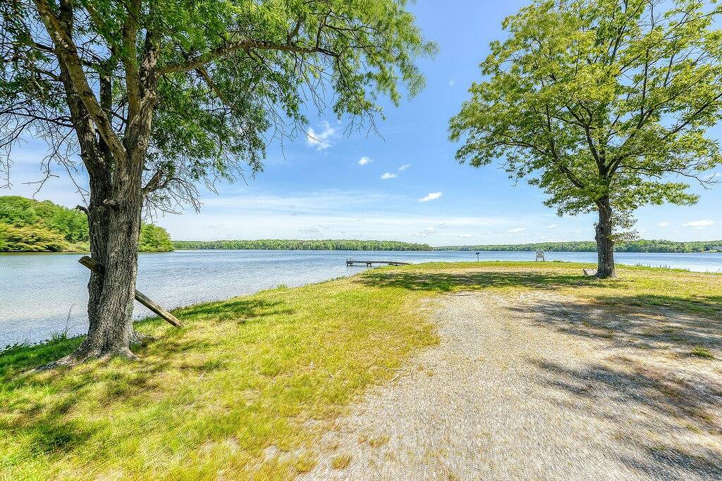 Three-story lakefront home w/ covered boat slip, and tennis/pickleball access in Lake Anna