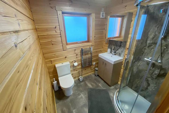 A traditional Scandinavian style lodge, with stylish wooden interior decorated with a Scottish theme in Lothian