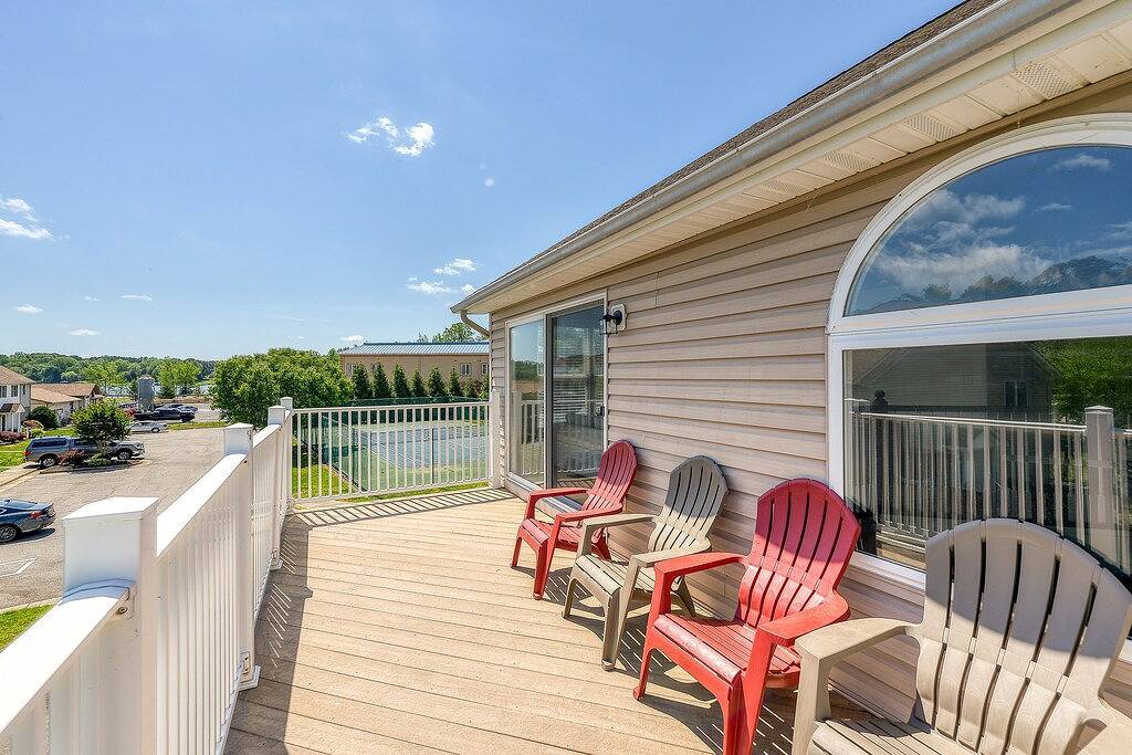 Three-story lakefront home w/ covered boat slip, and tennis/pickleball access in Lake Anna