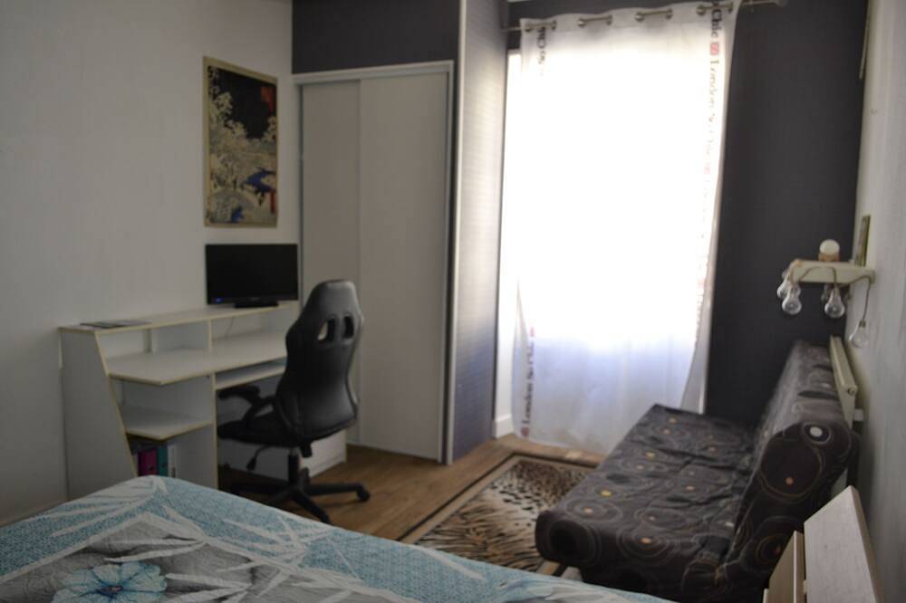 Large guest room with bed and sofa bed in Chef-Boutonne, Niort region