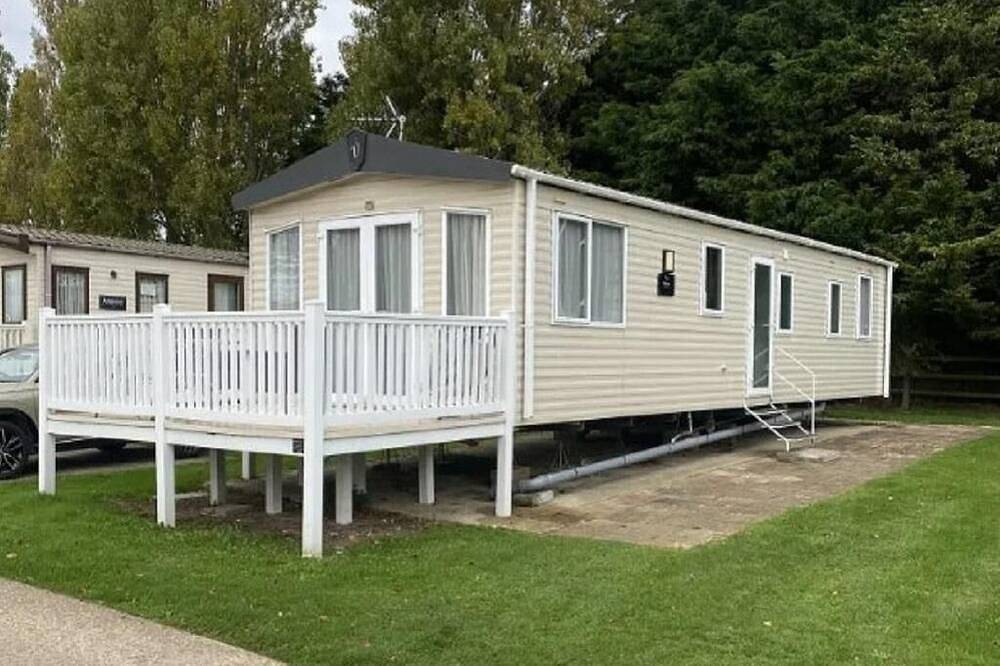 Caravan with front decking at Coopers Beach Holiday Park in Mersea Island, Colchester
