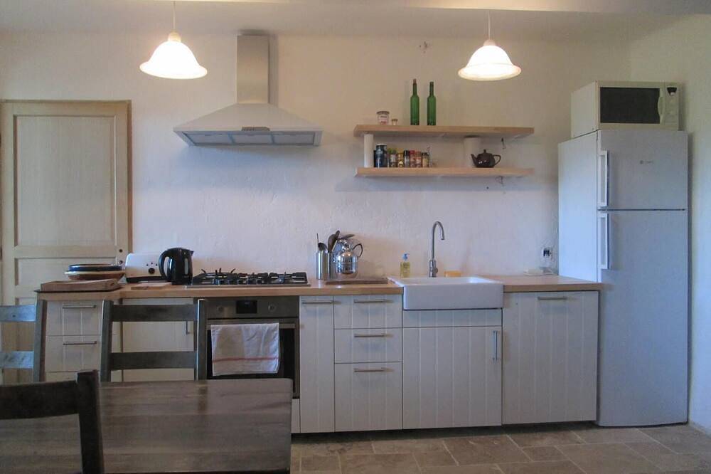 Provençal farm among olive trees; view of the hill from a large shaded terrace in Villecroze, Draguignan Region