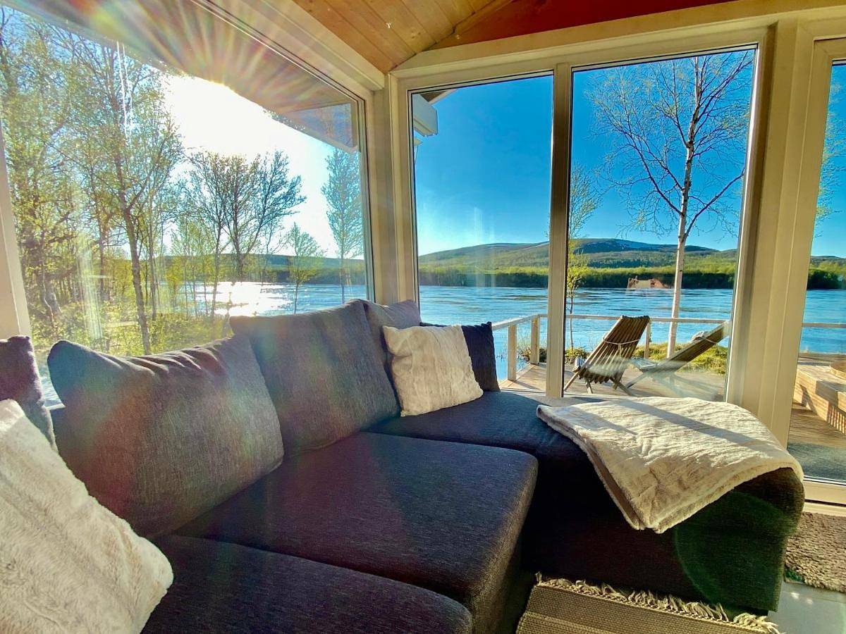 Aurora mökki kylpyaltaalla Lapissa Tenojoen rannassa in Nuorgam, Lappland