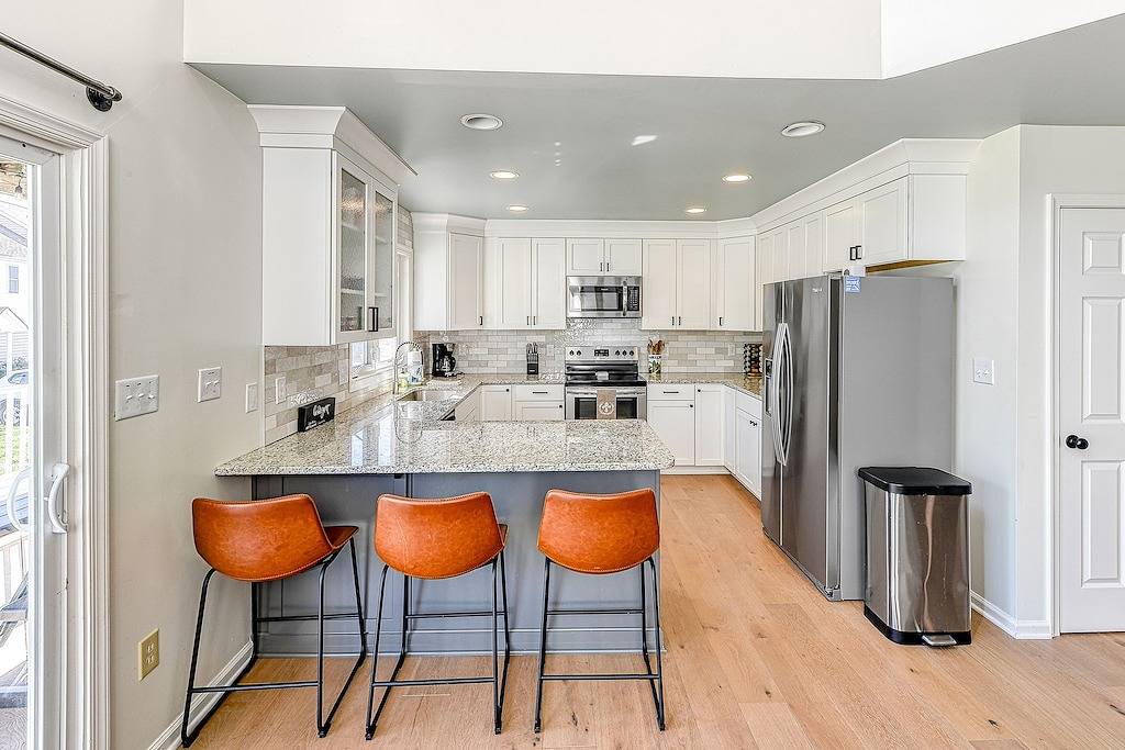 Three-story lakefront home w/ covered boat slip, and tennis/pickleball access in Lake Anna