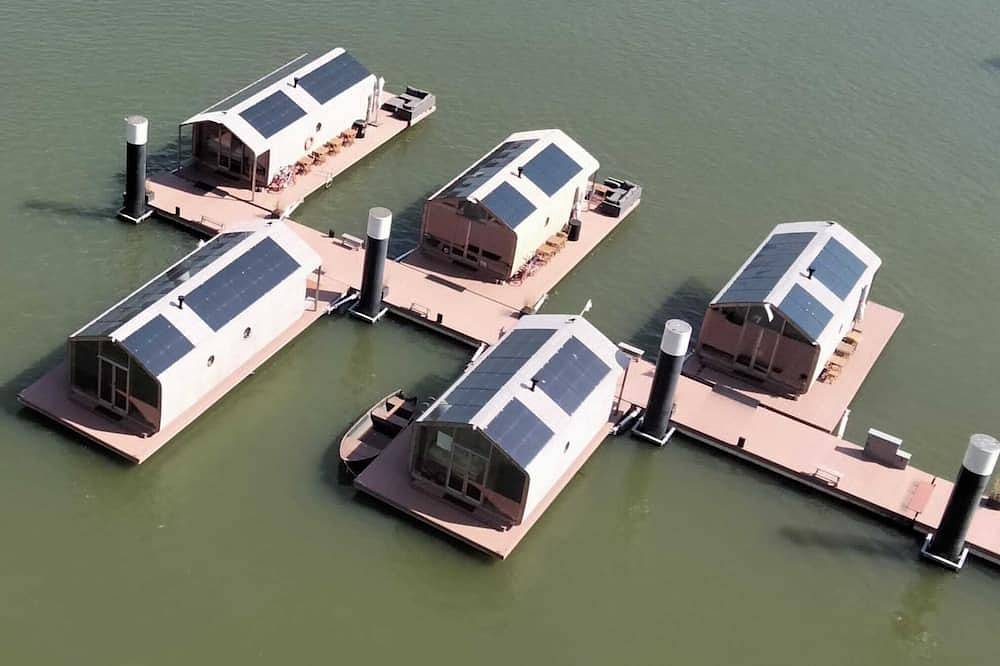 Wrap Boat No. 2 at Floating Rotterdam Rijnhaven with open swimmingpool nextdoor in Rotterdam, Südholland