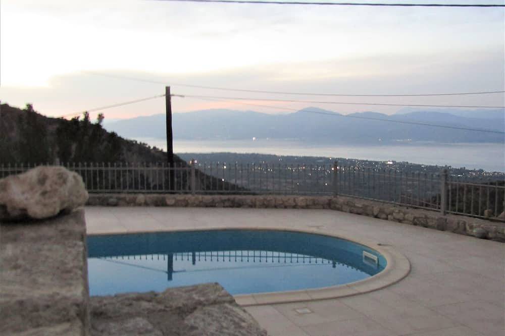 Stone house with pool and view to the sea in Achaia