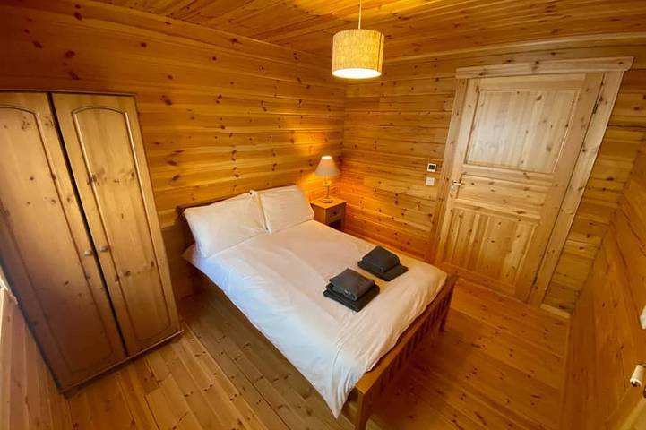 A traditional Scandinavian style lodge, with stylish wooden interior decorated with a Scottish theme in Lothian