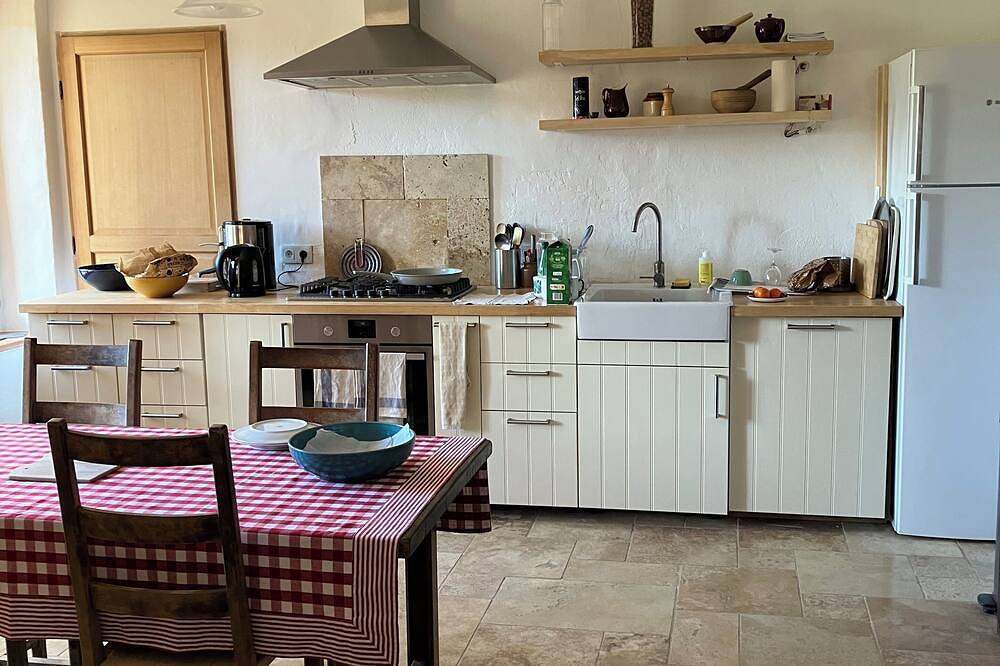 Provençal farm among olive trees; view of the hill from a large shaded terrace in Villecroze, Draguignan Region