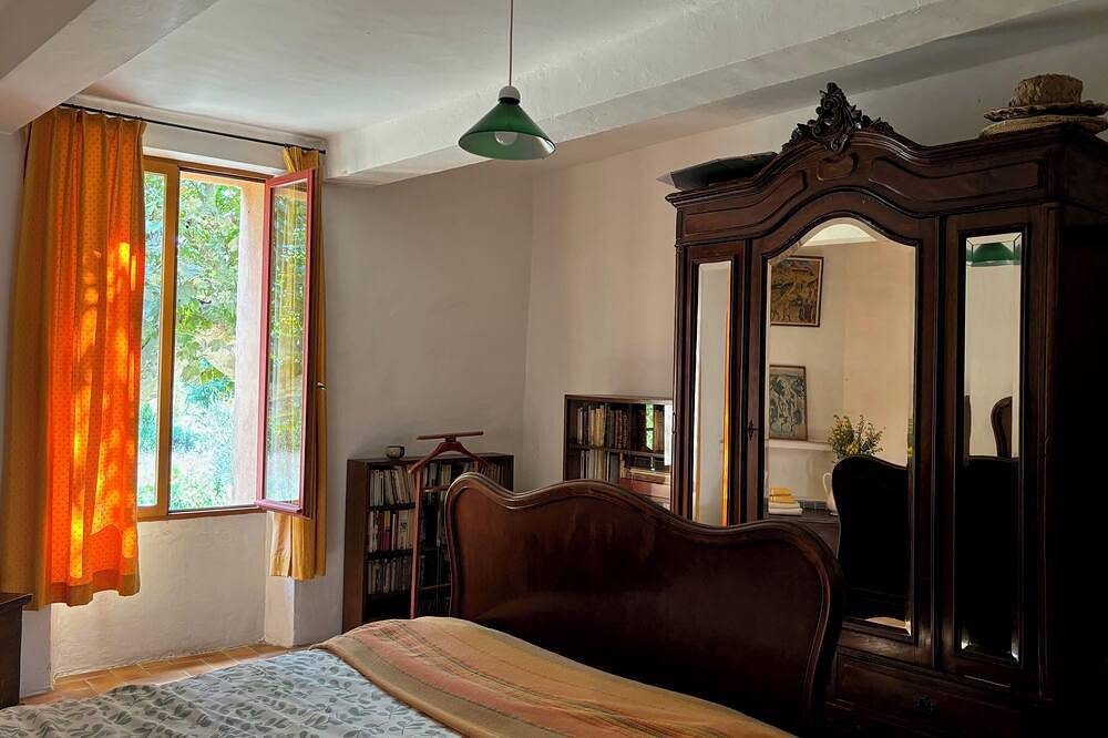 Provençal farm among olive trees; view of the hill from a large shaded terrace in Villecroze, Draguignan Region