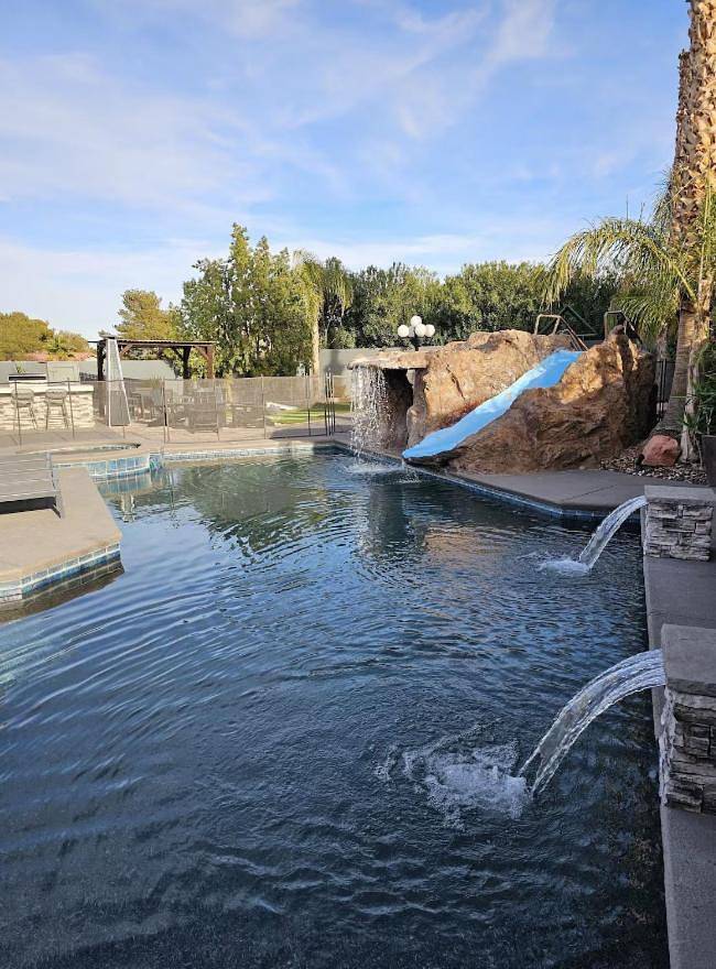 Luxury Villa, with bonus pool house, Private Pool, Hot tub, rock water fall and slide, putting green, basketball, shuffle board, play gym, privately gated on circular driveway. in Las Vegas, Red Rock Canyon